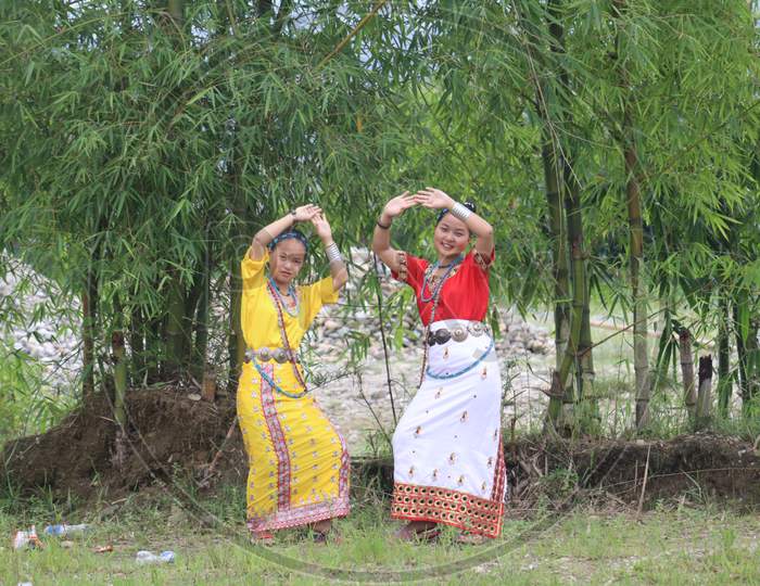 Two beautiful sisters from Arunachal Pradesh dancing traditional Nyishi Song Photo, North East India.