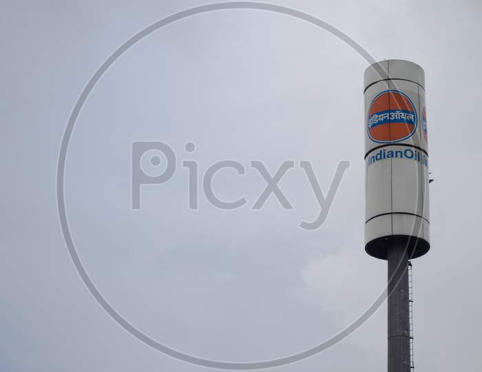 Signage Of Indian Oil Petrol Pump Shot Against A Monsoon Clouds And Blue Sky Showing India'S Largest Petroleum Manufacturer And Petrol Pump Owner