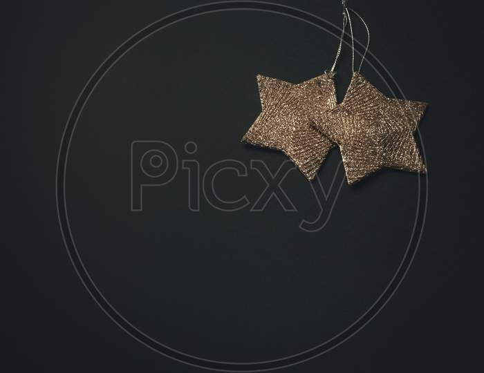 Christmas Flat Lay With Two Golden Stars Over A Dark Background With Copy Space