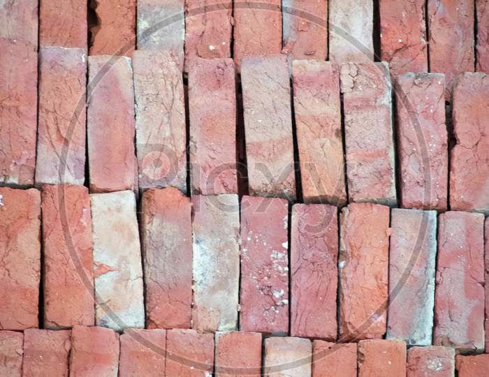 Pile Of Bricks Placed On The Ground, Showing The Pattern And The Distinctive Red Color