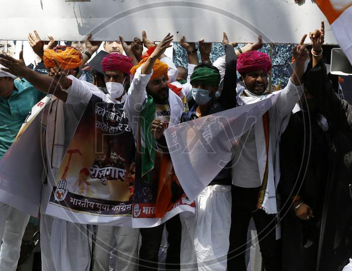 Member of India's opposition Congress party shout slogans during a protest against agriculture bills in New Delhi, India, Sept  22, 2020. Amid an uproar in Parliament, Indian lawmakers  approved a controversial agriculture bills that the government says will boost growth in  farming.