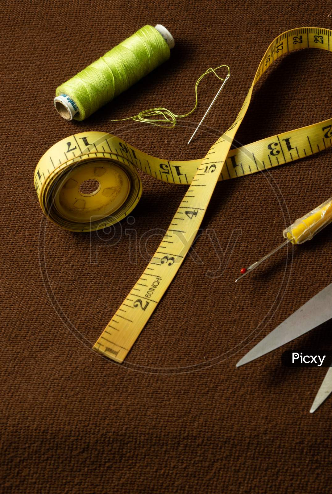 Tailoring Materials On A Brown Background