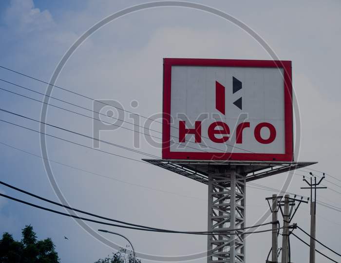 Signage At A Hero Motors Factory Shot Against A Monsoon Clouds And Blue Sky Showing India'S Largest Two Wheeler Manufacturer