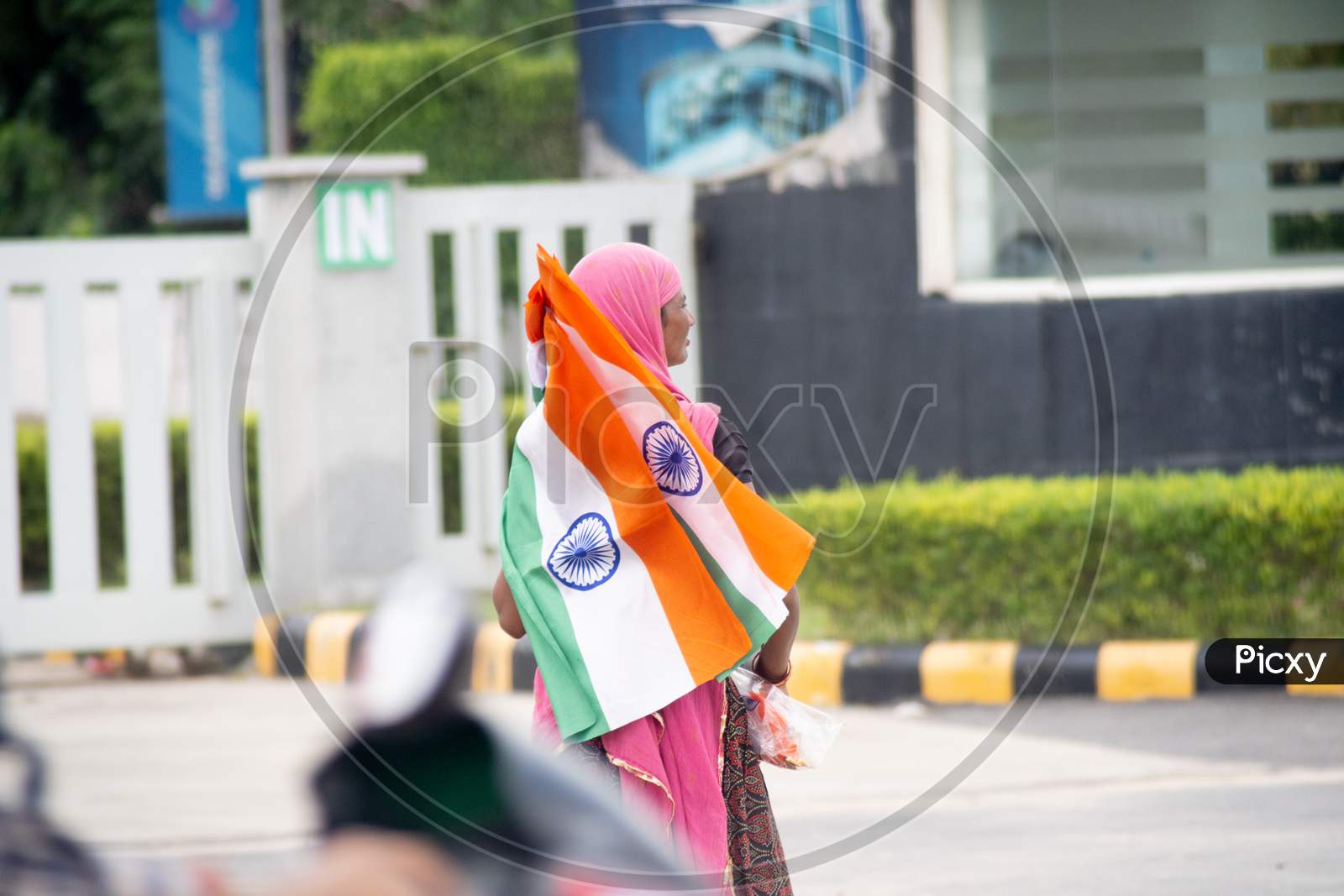 Poor Unemployed Indian Woman Selling The Indian Tricolor Flag On A Roadside On The Indian Festival Of Independence Republic Day