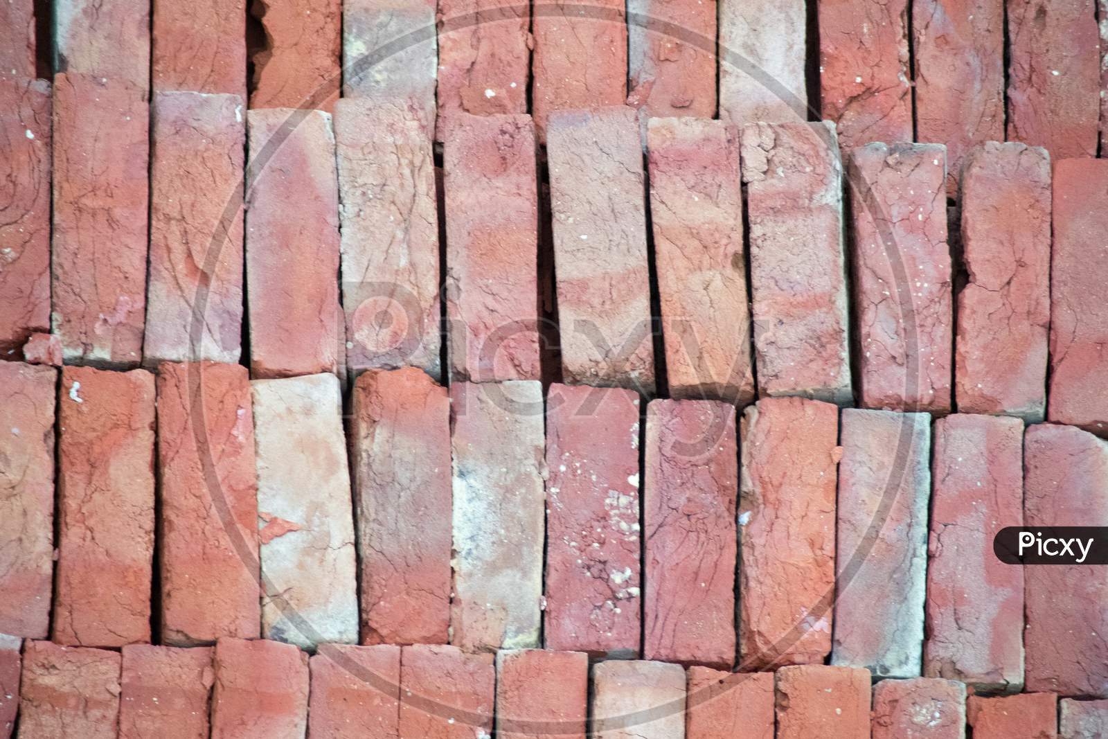 Pile Of Bricks Placed On The Ground, Showing The Pattern And The Distinctive Red Color