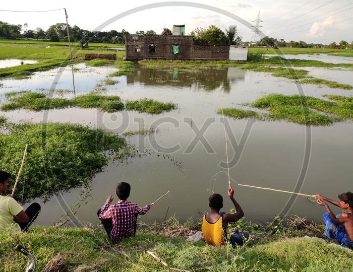 Children fishing in Monsoon season