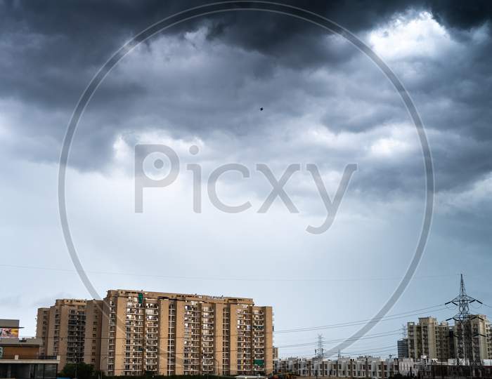Gurgaon Delhi Cityscape With Monsoon Clouds Casting Shadows On High Rise Apartments And Buildings Showing Passage Of Time And Rapid Growth Of Real Estate And Infrastructure