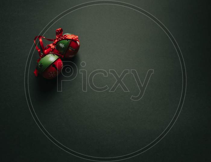 Christmas Flat Lay With Two Jingle Bells Over A Dark Background With Copy Space