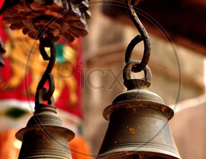 Two ancient type bells hanging in a temple