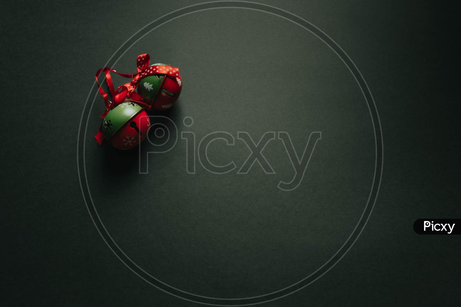 Christmas Flat Lay With Two Jingle Bells Over A Dark Background With Copy Space