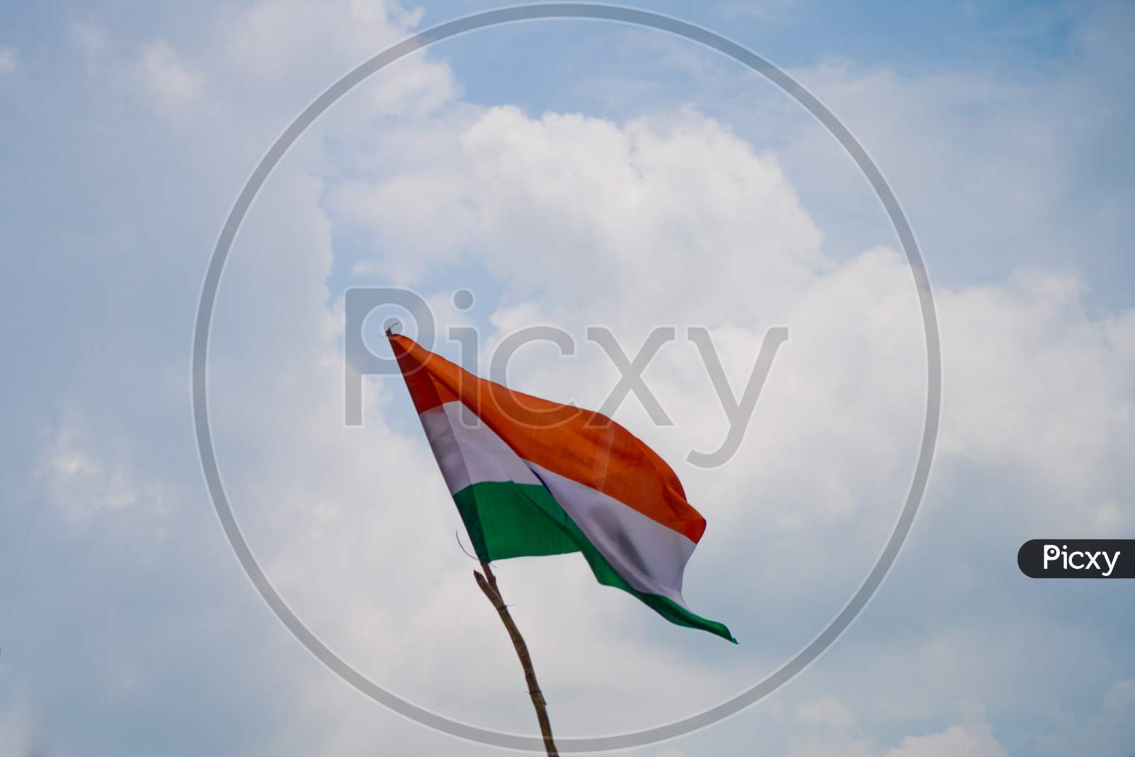 Indian Tricolor Flag Mounted On A Makeshift Stick Shot Against A Cloudy Sky On A Patriotic Republic Independence Day