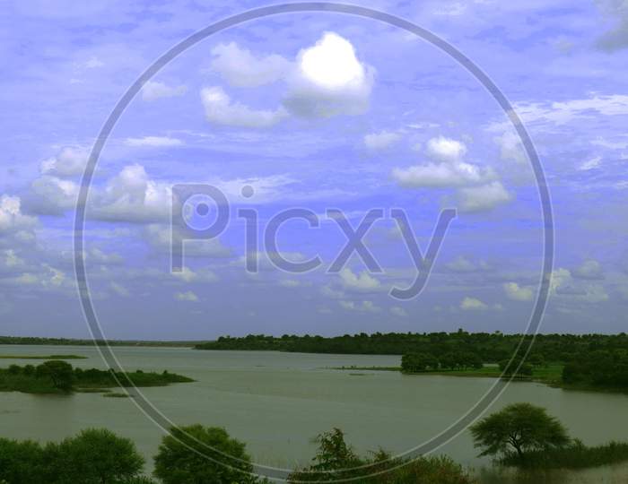 landscape photo with blue sky and green trees and nature