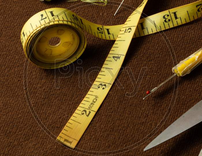 Tailoring Materials On A Brown Background