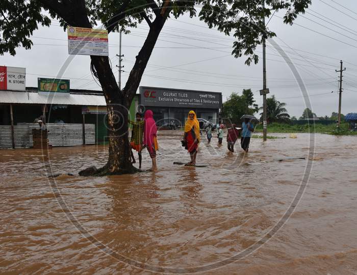 Commuters wade through a waterlogged street following heavy rainfall, at Boragaon in Guwahati on Tuesday, Sept. 22, 2020.
