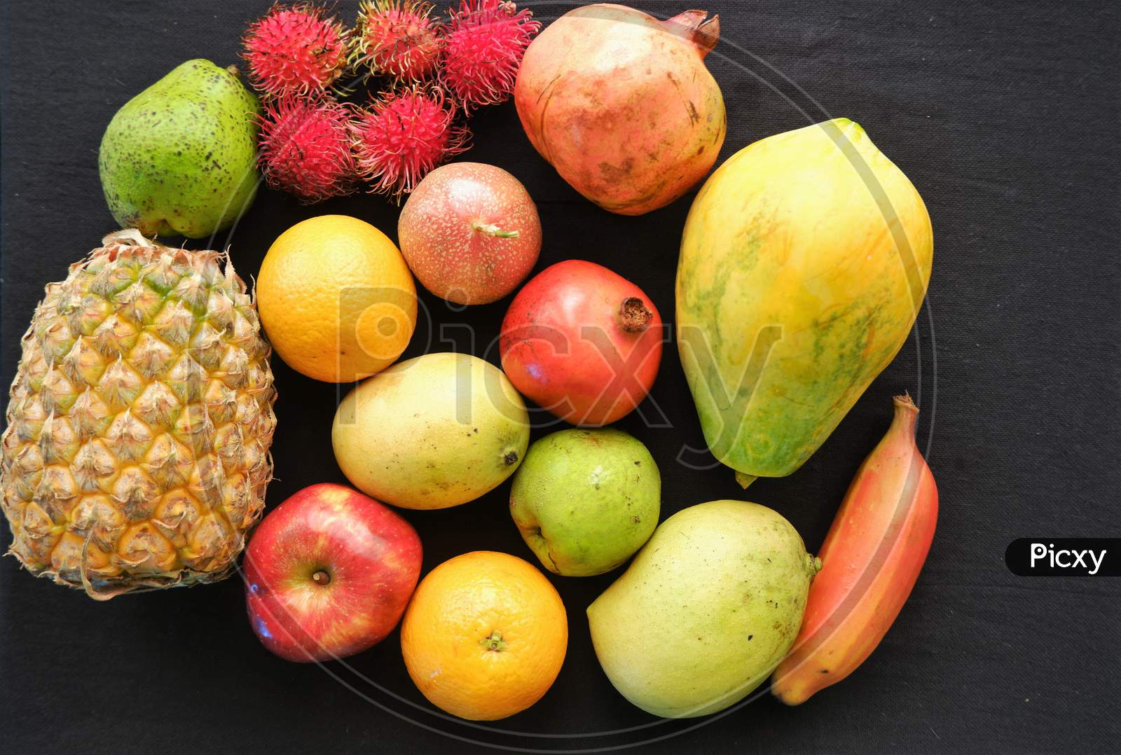 Healthy assorted natural fruits on black background ,top view,