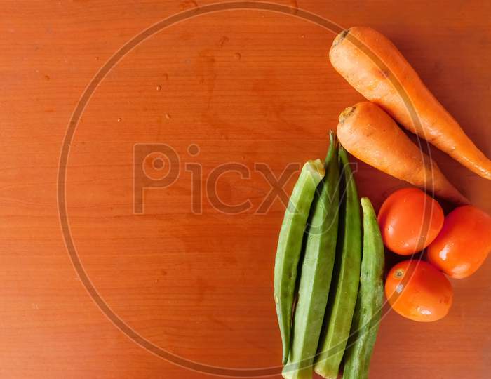 Closeup Of Vegetables Isolated On A Wooden Surface