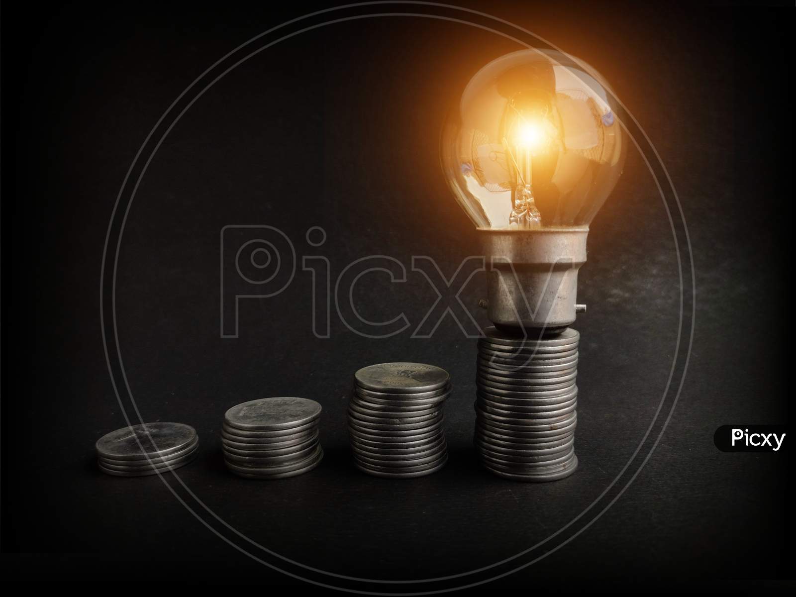 light bulb with coins stack. Creative ideas for saving money concept. Money management for the future, energy saving