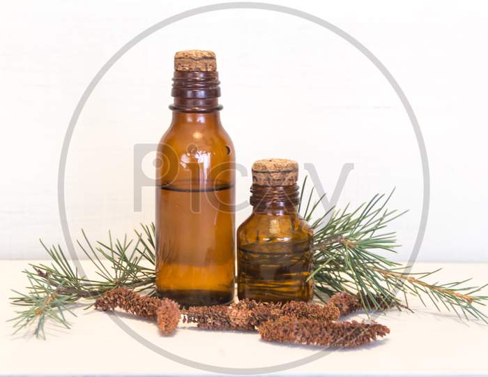 Bottles With Cedar Oil. Aromatherapy And Natural Cosmetics Concept