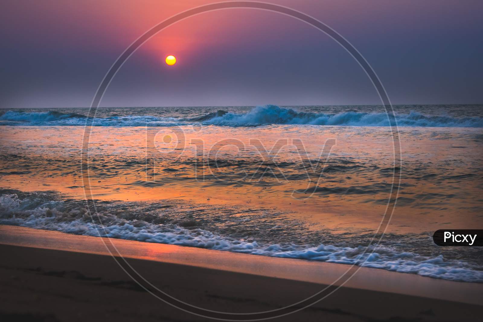 Beautiful Sunrise Over The Beach In Long Exposure. Moving Elements Sunrise And Wave Photography From The Beach In Chennai, India. Red Sky In Bay Of Bengal. Sea Waves Photography. Ecr Beach