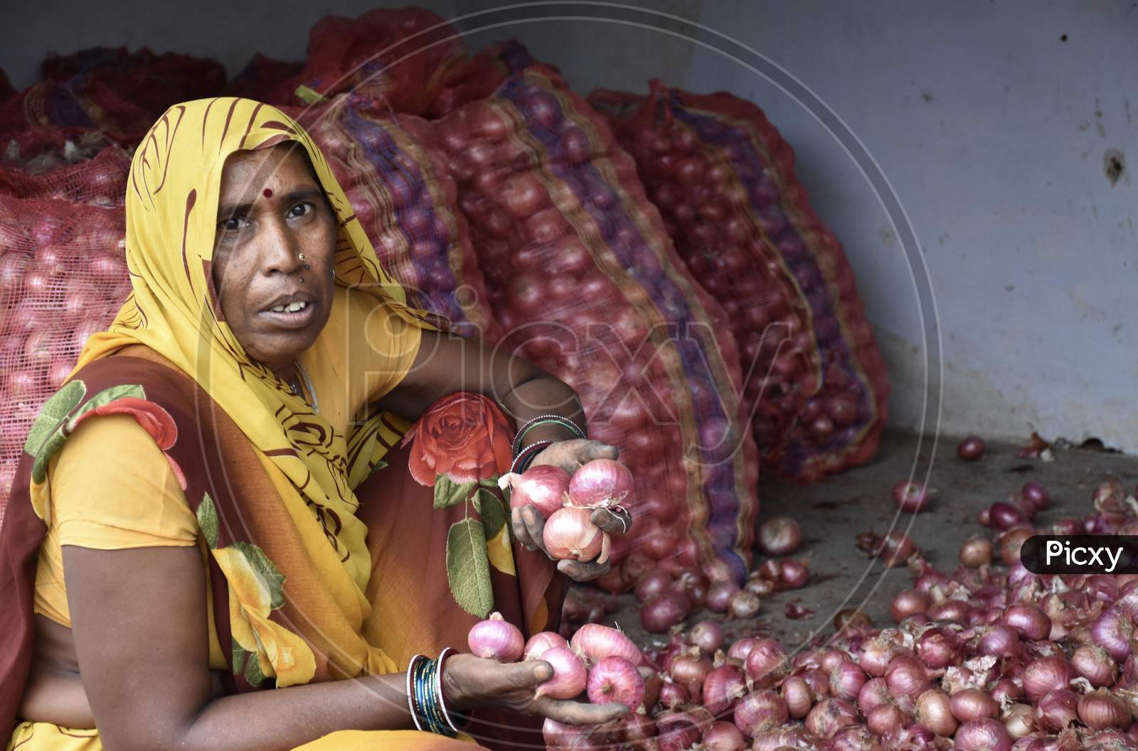 Indian Woman Cleaning Rotten Onions