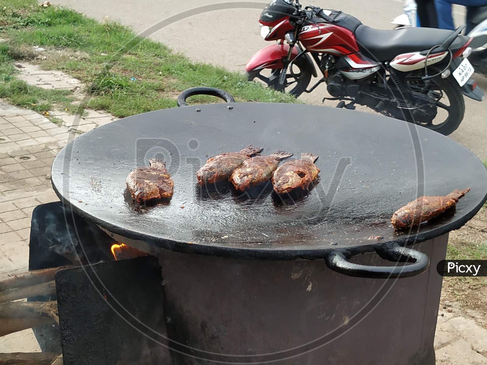 Fish Frying in a Tawa on Road Side of the Bangalore at Evening Time