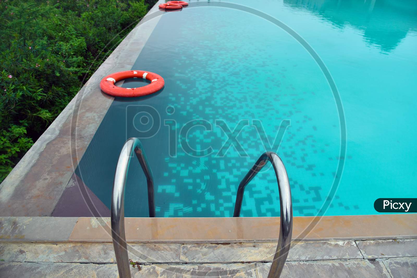 Sky Blue Water In Infinity Swimming Pool At Forest Villa In India.