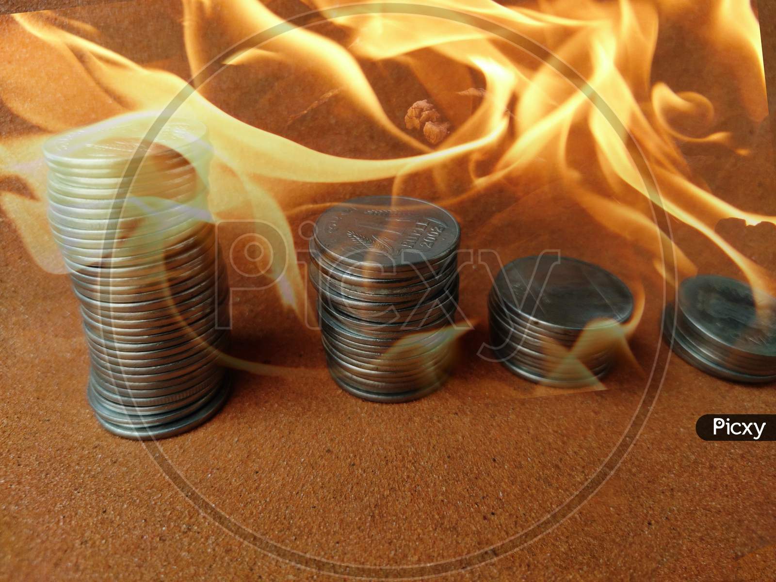 Coin stack step down graph in fire ,Stock market fall, Risk management. Money management fail,