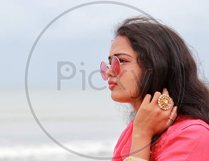 A Portrait Head Shot Of A Beautiful Young Indian Woman Standing Alone On The Shores Of Chennai, Profile View