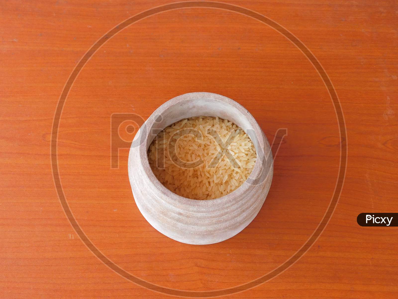 Closeup Of Rice In A Bowl Isolated On A Wooden Surface