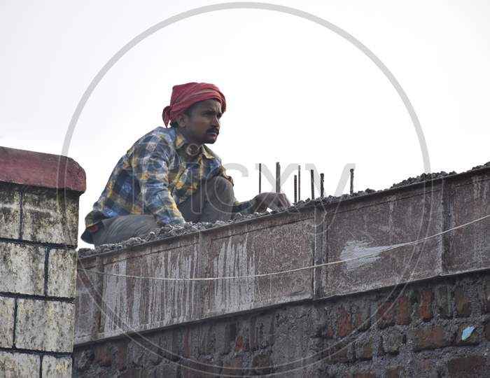 A Man Working On Roof Of The House