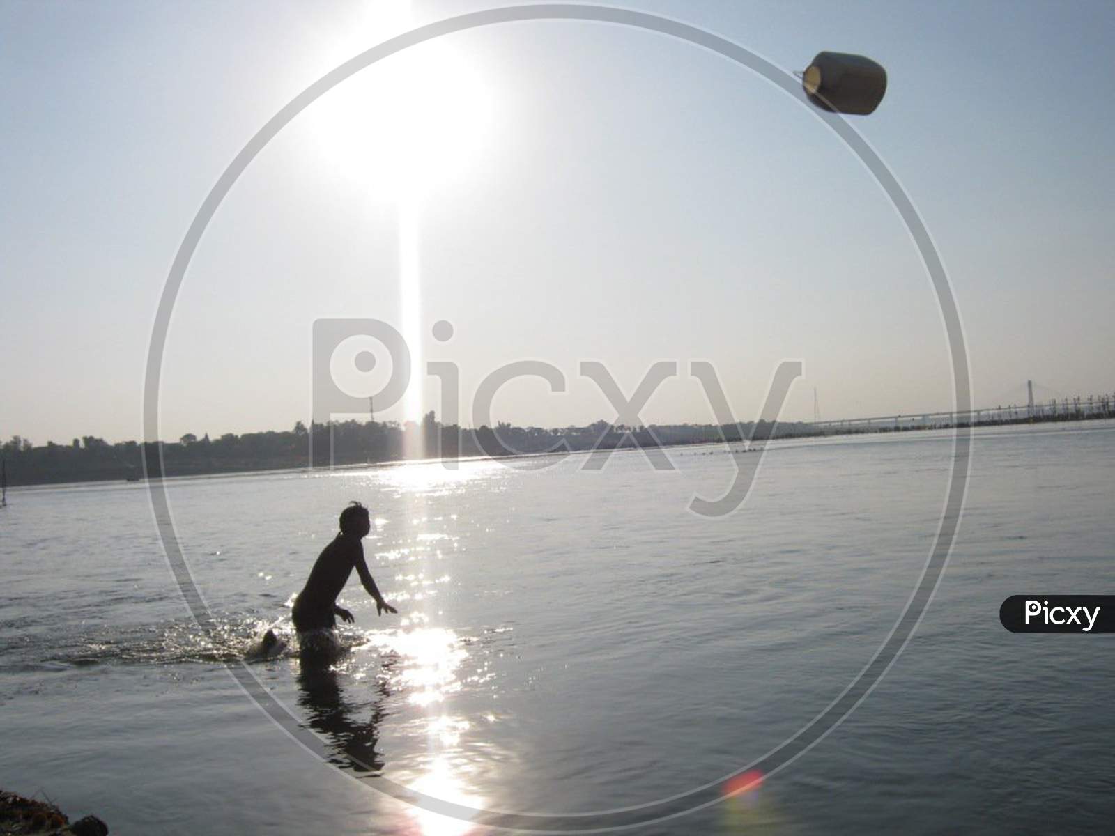 a boy play in the river ganga at sangam allahabad