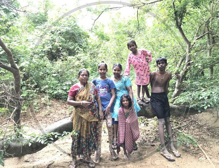 Group Of People Or Relatives Are Traveling Inside The Forest Towards The Waterfalls During Their Vacation And Enjoying Together