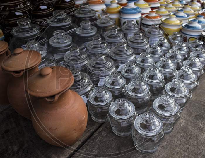 Mud Pots, Glass And China Vessels On A Wooden Table At A Street Shop
