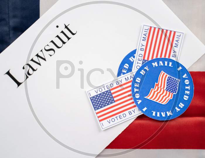 I Voted By Mail Stickers On Lawsuit Paper With Us Flag As Background - Concept Of Lawsuits In Usa Election.