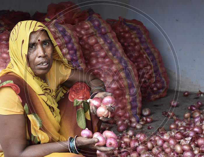 Indian Woman Cleaning Rotten Onions