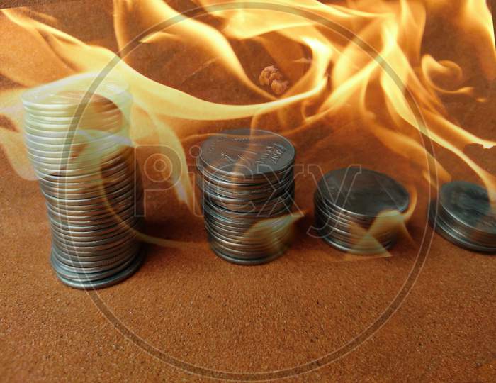Coin stack step down graph in fire ,Stock market fall, Risk management. Money management fail,