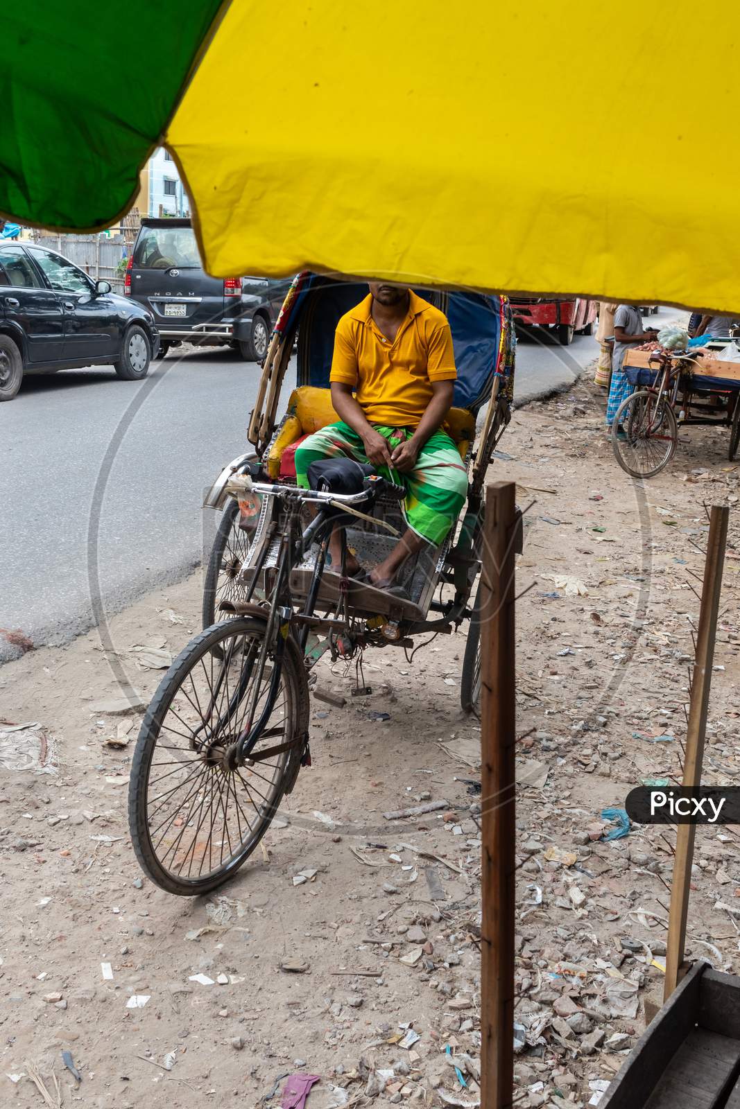 A Rickshaw Puller Doing Hard Job Under Hot Summer Sun Shine.
