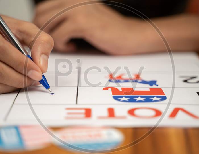 Close Up Of Hands Voting By Selecting The Political Party At Polling Booth - Concept Of Polling At Us Election.
