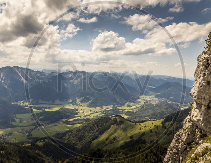 Hiking from the mountain station to the top of the mountain called Wendelstein in Bavaria, Germany at a cloudy day in summer. Beautiful panoramic view.