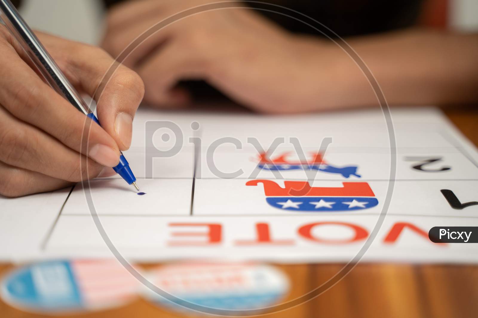 Close Up Of Hands Voting By Selecting The Political Party At Polling Booth - Concept Of Polling At Us Election.