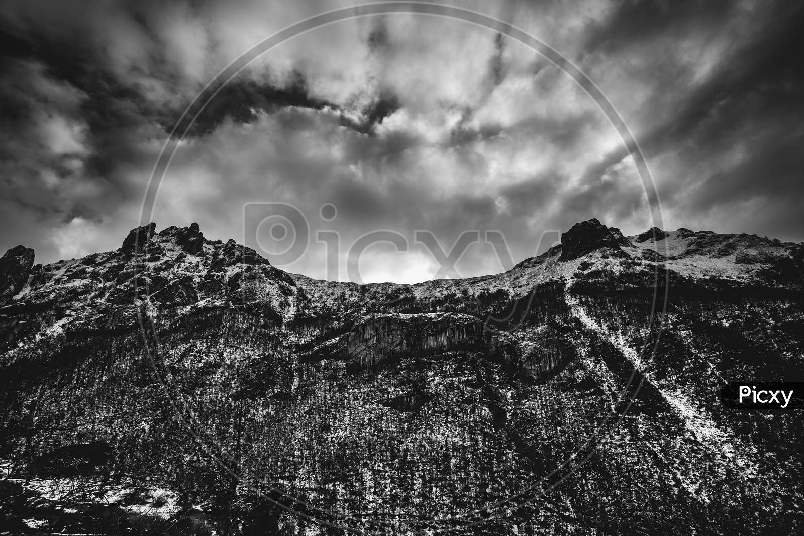 Dramatic Black And White Of The Snowy Mountains During A Cloudy Day With Copy Space