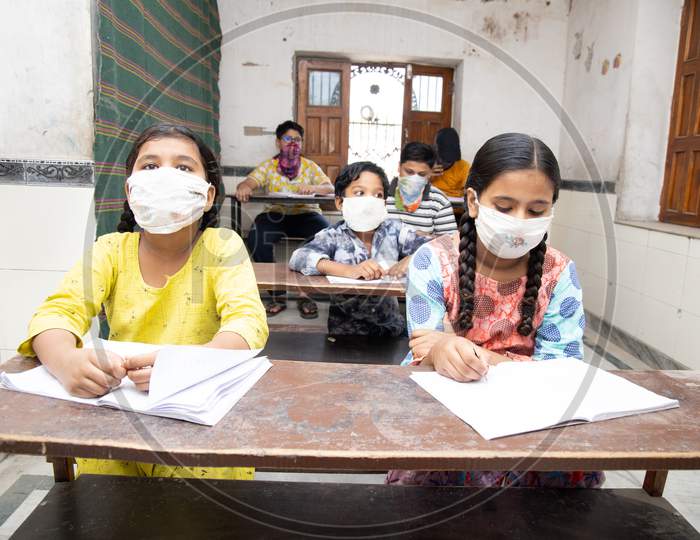 Indian Students Studying In Classroom Wearing Mask And Social Distancing, School Reopen During Covid19 Pandemic
