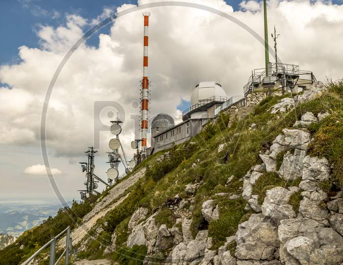 Wendelstein, Bavaria/Germany - July 17th 2020: A german photographer visiting the Wendelstein mountain via cable car, taking pictures of the weather station at the top of the mountain.