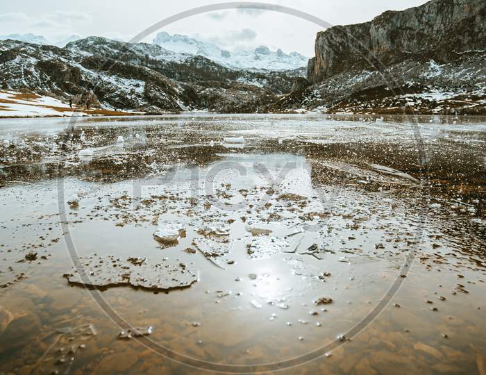 Frozen Water And Pieces Of Ice In A Frozen Lake In The Middle Of The Mountains During Winter
