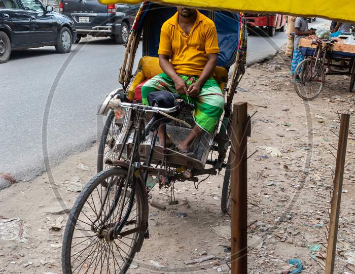 A Rickshaw Puller Doing Hard Job Under Hot Summer Sun Shine.