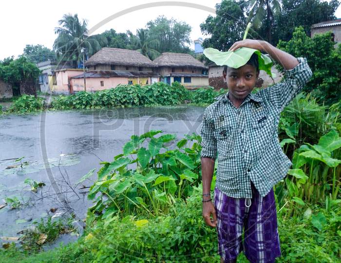 A Naughty Village Boy Of India Is Enjoying The Rain