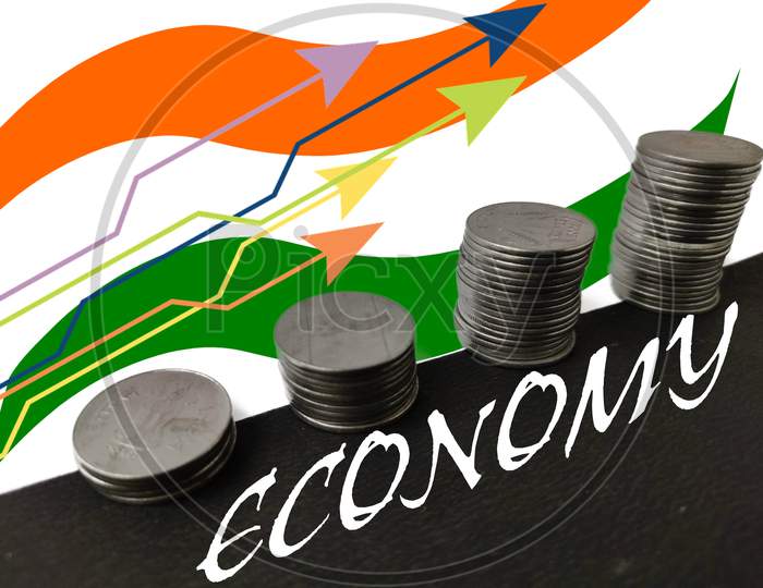 Economy increase concept by Coins and trend line with indian flag in background