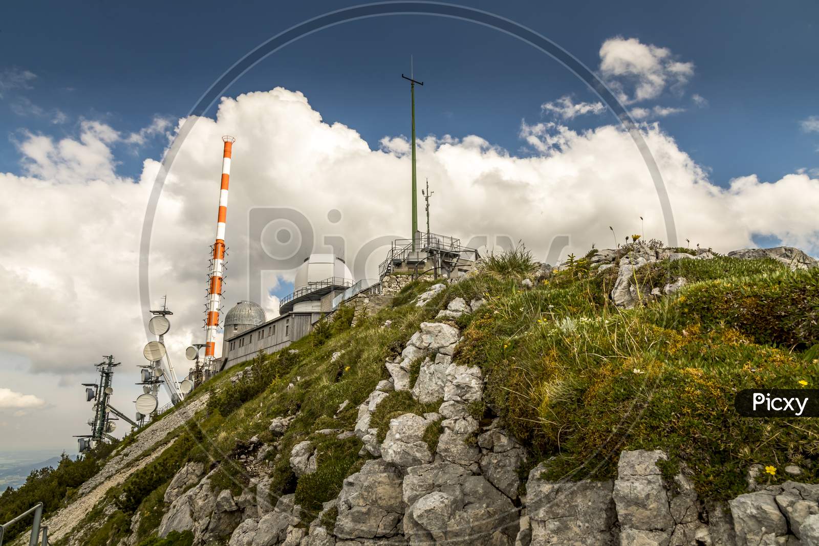 Wendelstein, Bavaria/Germany - July 17th 2020: A german photographer visiting the Wendelstein mountain via cable car, taking pictures of the weather station at the top of the mountain.