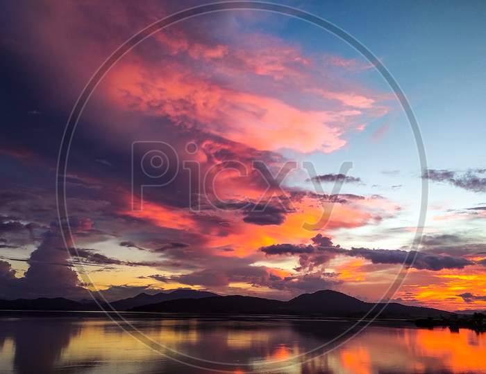 A beautiful sunriseset scenery of mountains and river