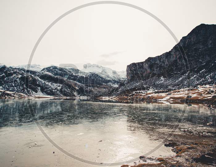 Stunning And Relaxing View Of A Frozen Lake In The Snowy Mountains Of Asturias